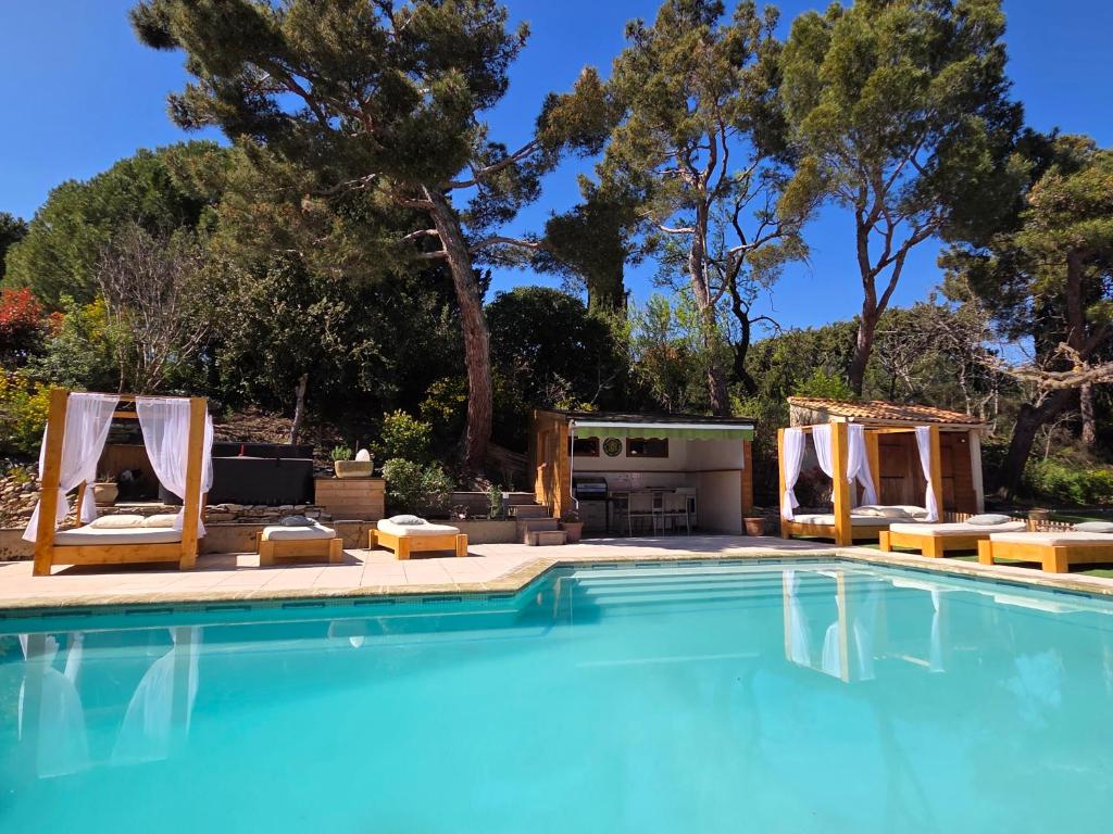 a swimming pool with lounge chairs and a swimming pool at Domaine Les Gendalis in Saint-Saturnin-les-Avignon