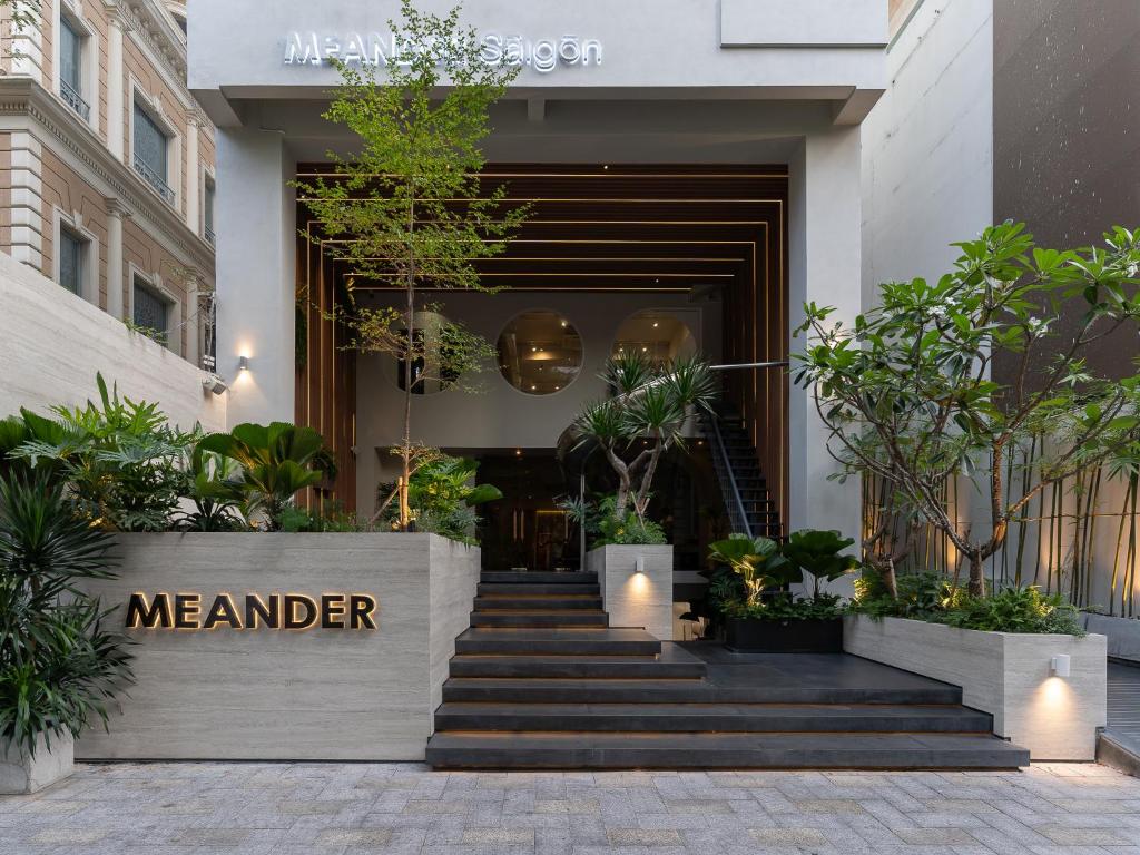 a lobby of a meander building with stairs and plants at MEANDER Saigon in Ho Chi Minh City