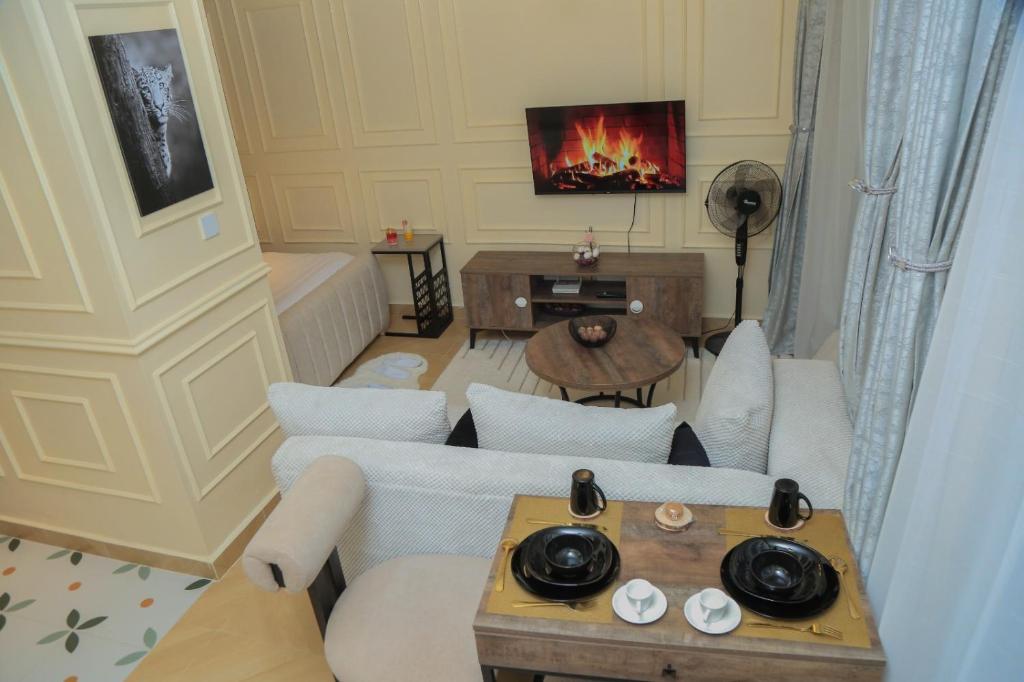 a living room with a couch and a tv at Executive-Studio-Apartmen in Nairobi