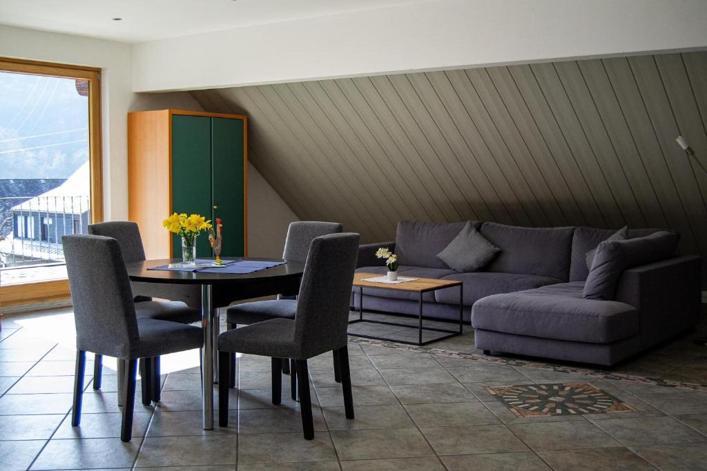 a living room with a couch and a table and chairs at Ferienweingut Kreuz-Bauer in Minheim
