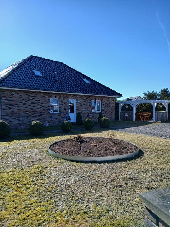 a house with a garden in front of it at Kranich in Wieck