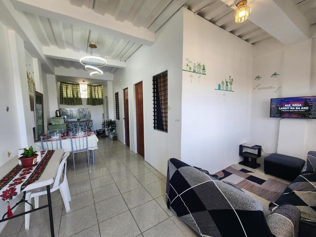 a living room with a couch and a table at Caishen Apartelle 201 in Sabutan