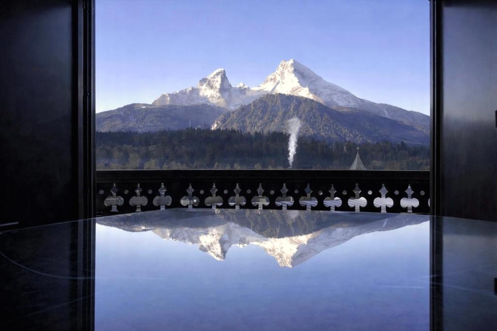 a view of a mountain from a window with birds at Rottenhöfer Retreat Villa in Berchtesgaden