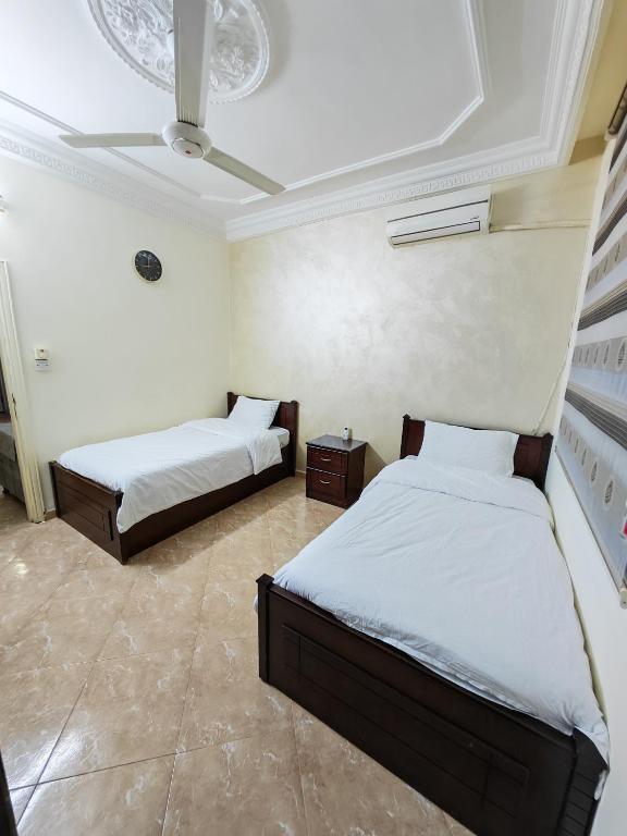 a bedroom with two beds and a ceiling at Luxury Apartment in Aqaba in Aqaba