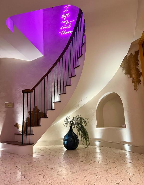 a staircase in a building with a purple light at Chic Devon Designer Oasis with hot tub in Malborough