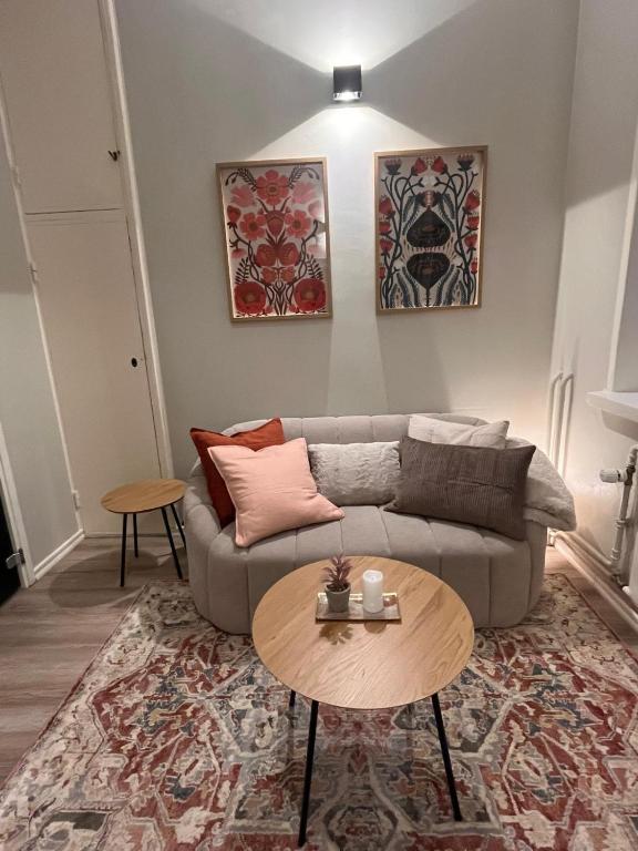 a living room with a couch and a table at Central Kamppi Micro Loft, Quiet Courtyard in Helsinki