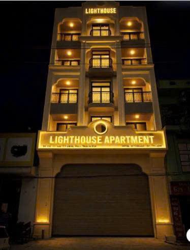 a light house apartment building with a sign on it at Lighthouse Apartment in Ða Gia