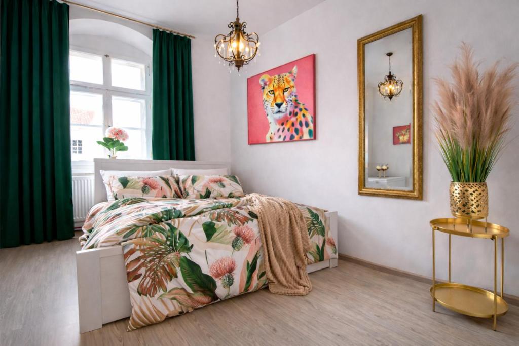 a bedroom with a bed and a painting on the wall at Old Town Studio - Stay Olomouc CZ in Olomouc