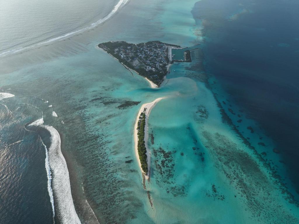 an aerial view of an island in the ocean at Alyraa Sunset Mathiveri - Free Picnic Island Trip Included in Mathiveri