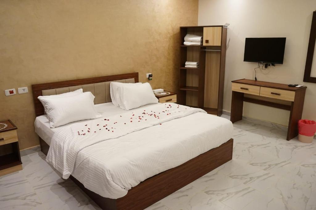 a bedroom with a large bed with flowers on it at Pr Pyramids Inn in Cairo