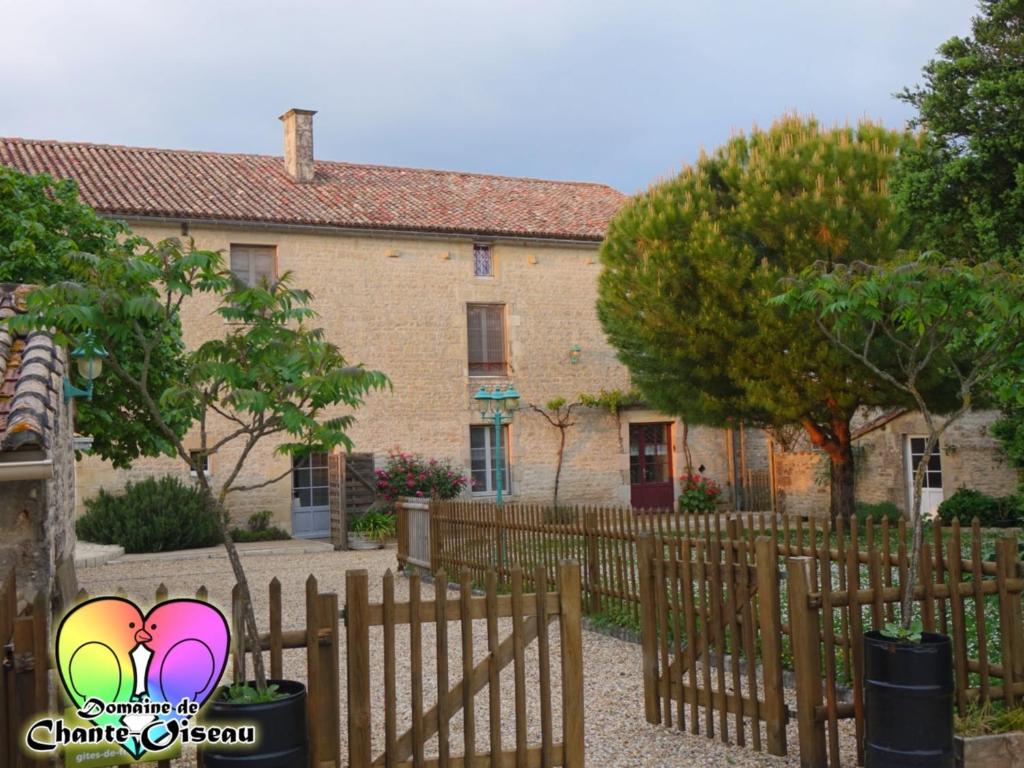 a house with a fence in front of it at Domaine De Chante-Oiseau - 28 pers in Theil-Rabier