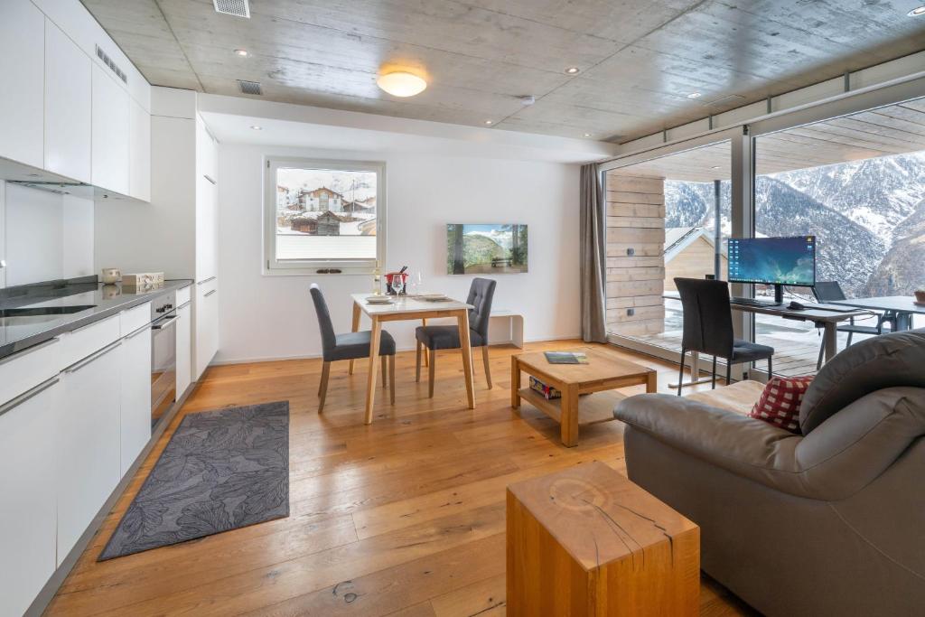 a living room with a couch and a table at Schwarzhornblick in Grächen