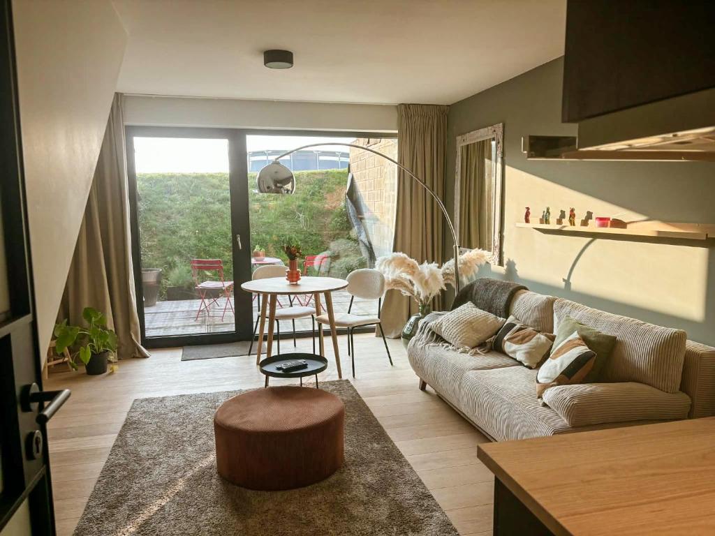 a living room with a couch and a table at La Rosière en Gaume in Musson