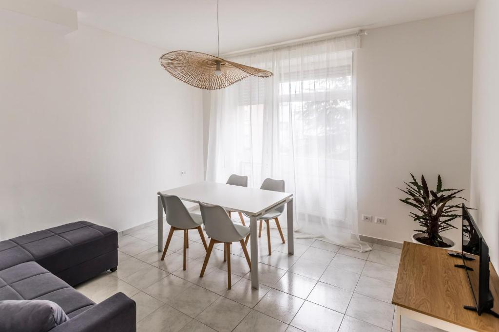 a living room with a table and chairs and a couch at Alpoggiouno in Vercurago