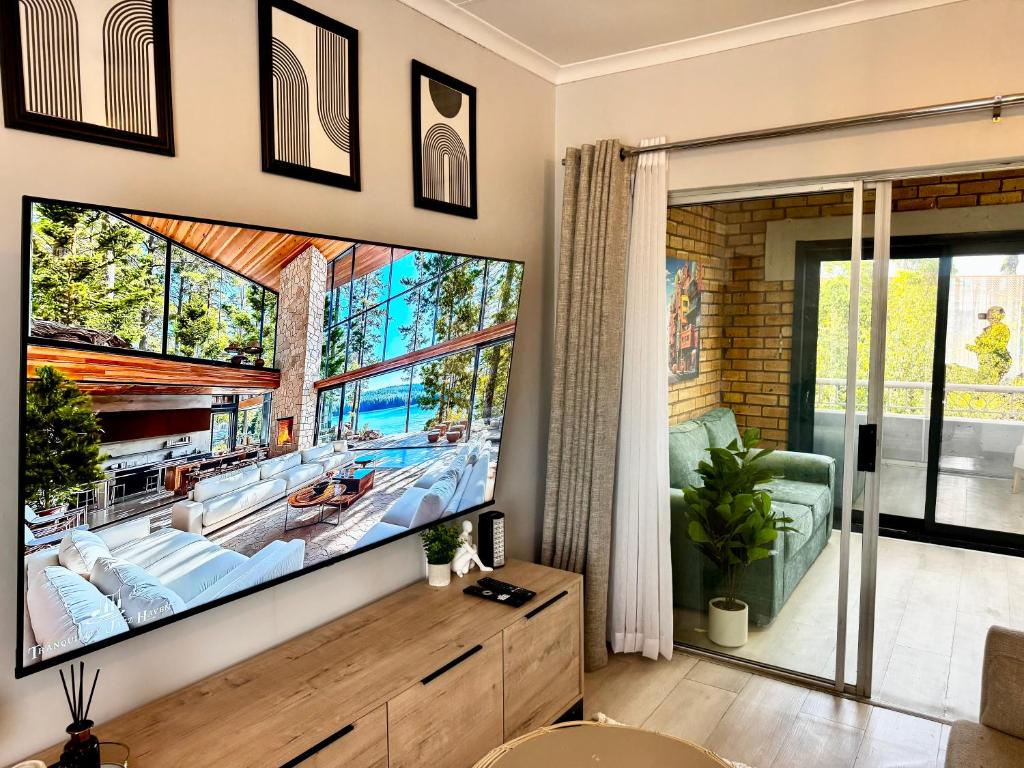 a living room with a large flat screen tv at Centurion La Creme Apartments in Centurion