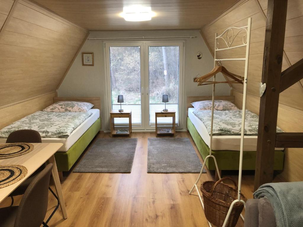 a bedroom with two beds and a window at Ferienhaus Plöwen MV in Plöwen
