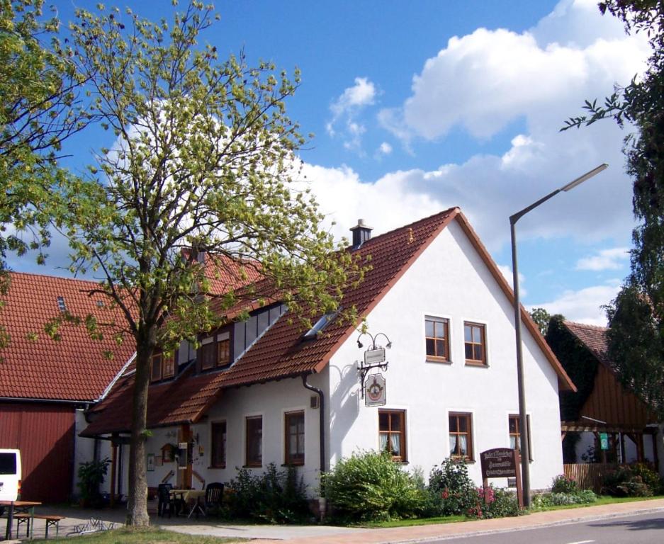a white house with a brown roof at Wohlfühlbauernhof in Geslau