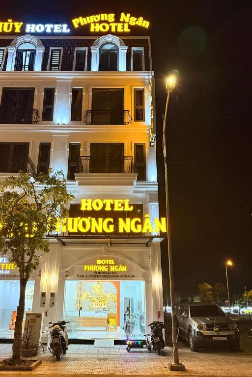 a hotel building with motorcycles parked in front of it at Phương Ngân HOTEL in Hà Tiên