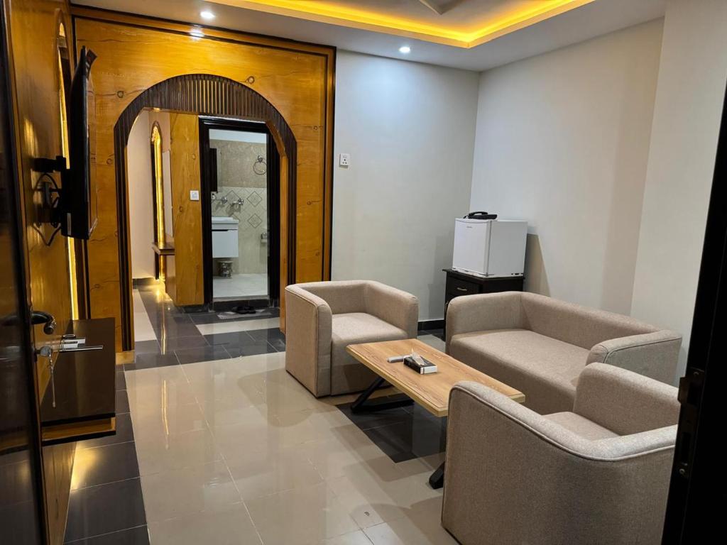a waiting room with two chairs and a table at Peaceful Stay In Peshawar in Peshawar