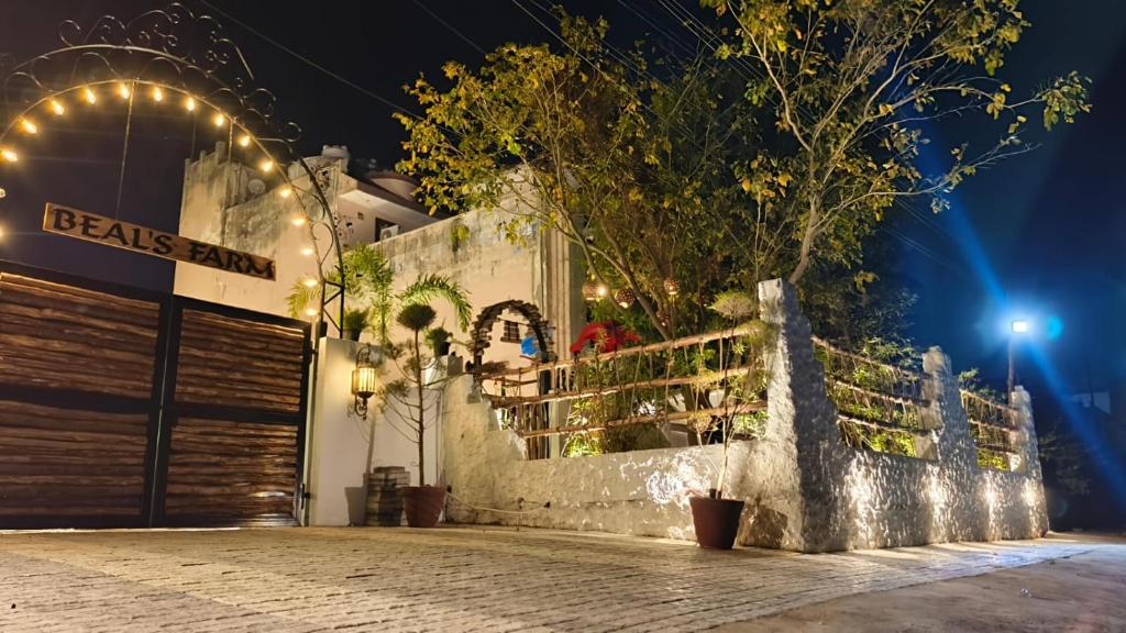 a building with lights on a street at night at Asmi by Beal's Farm in Jaipur