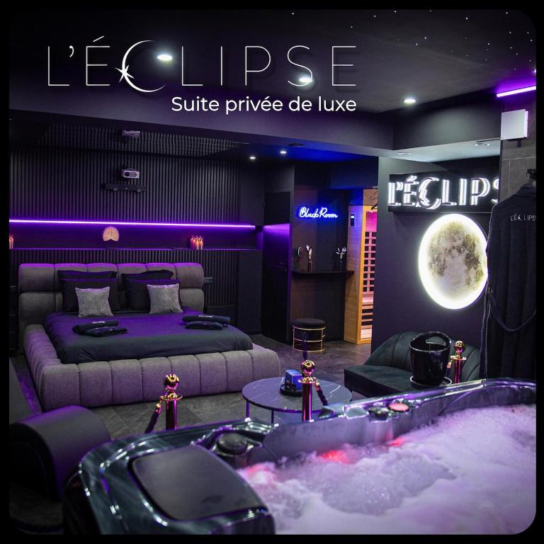 a room with two beds and a bathtub in the middle of it at L'Eclipse - Exceptional SPA Suite, sauna and hammam in Douai
