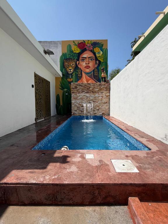 a swimming pool with a painting on the side of a building at suites ejecutivas centro guadalupe in Monterrey
