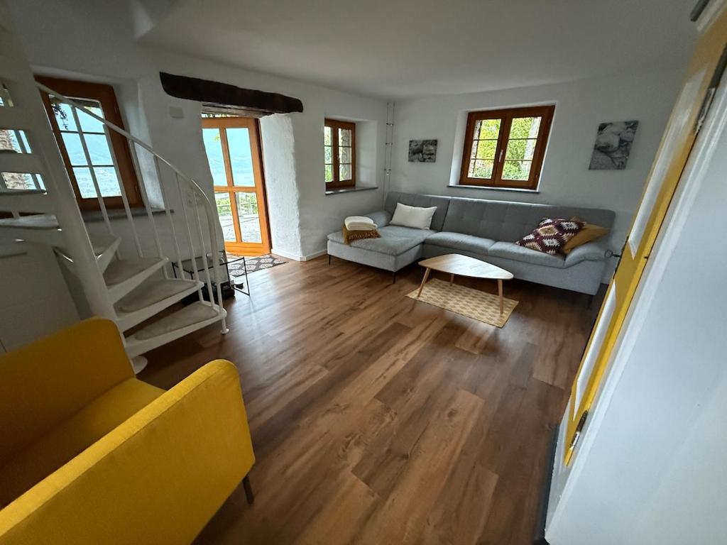 a living room with a couch and a table at Romantic Ticino Rustici in Gordola