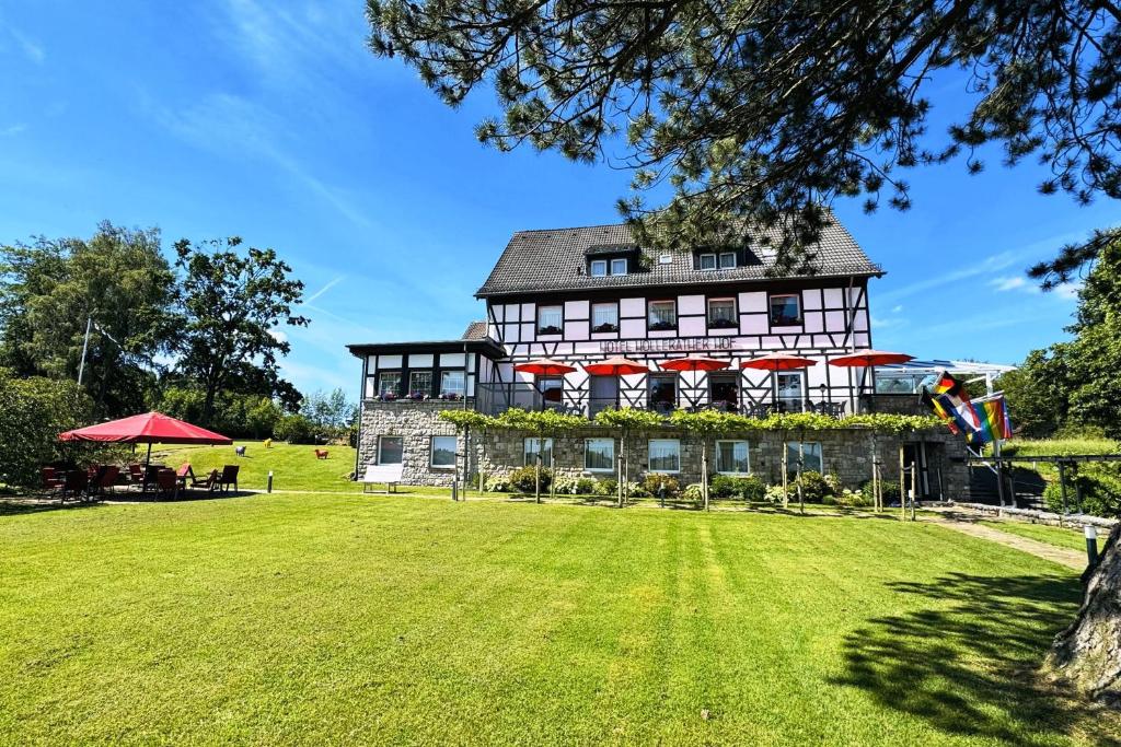 a large house with a large lawn in front of it at Boutique Hotel Restaurant Hollerather Hof in Hellenthal