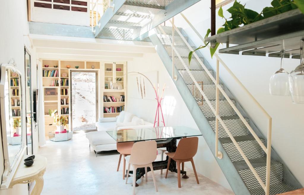 a dining room with a glass table and chairs at Casa Utopia in Santarcangelo di Romagna