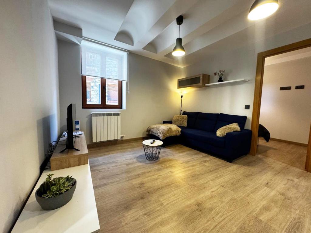 a living room with a blue couch and a table at Villmor - B39 - Rabason in Benasque