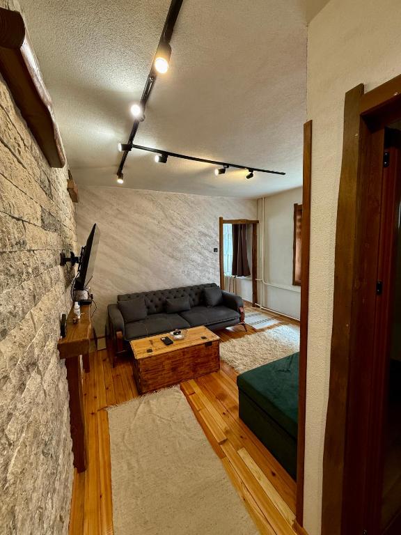 a living room with a couch and a table at Krisiya's Apartment in Bansko