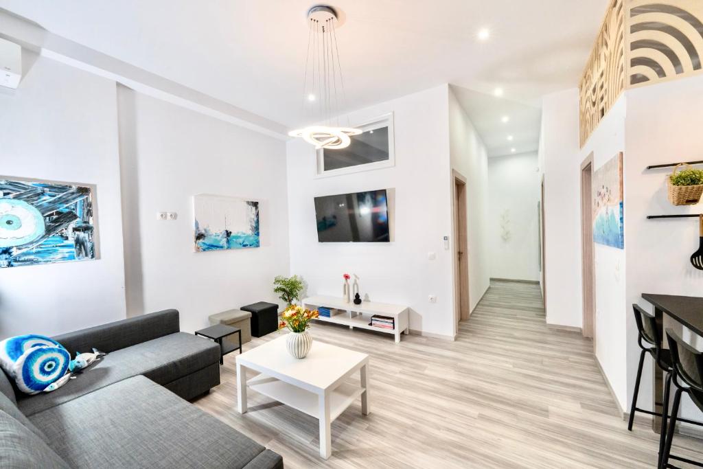 a living room with a couch and a table at Central Suites Aegina 2 in Egina