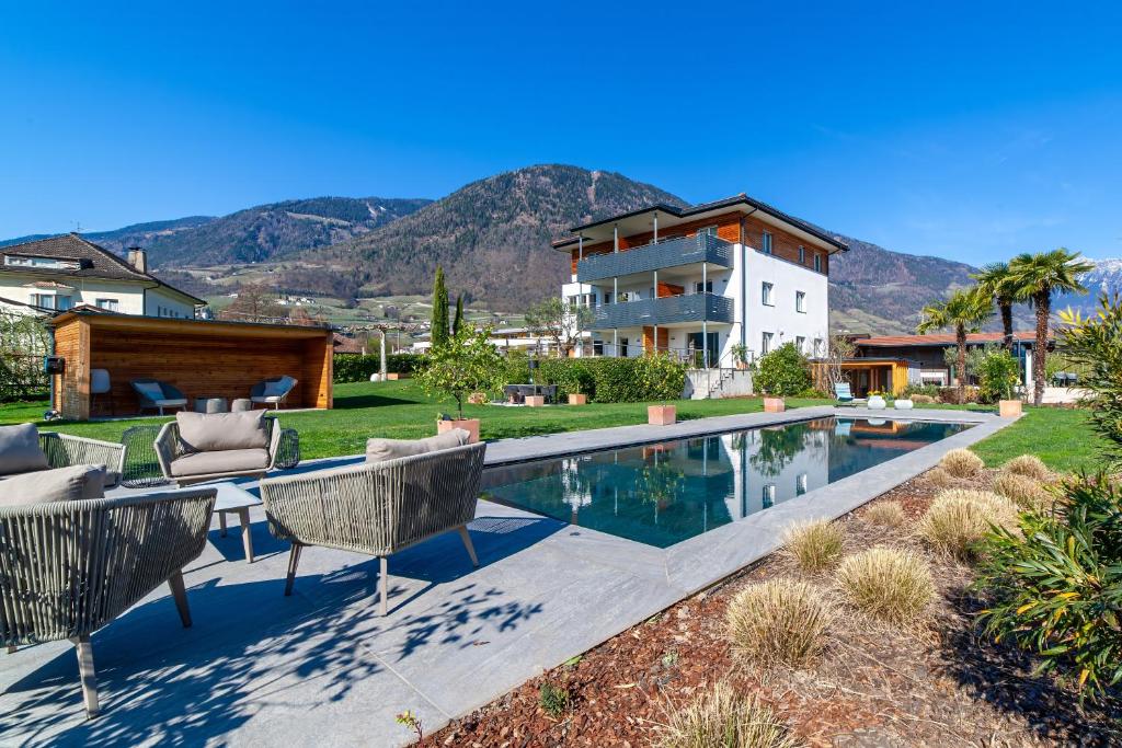 a house with a swimming pool in front of a house at Haus Wiesenstein in Lana