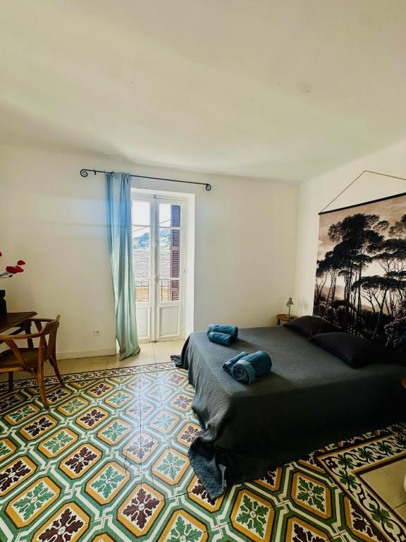 a bedroom with a bed and a large window at Maison colette CORDOLIANI in Brando