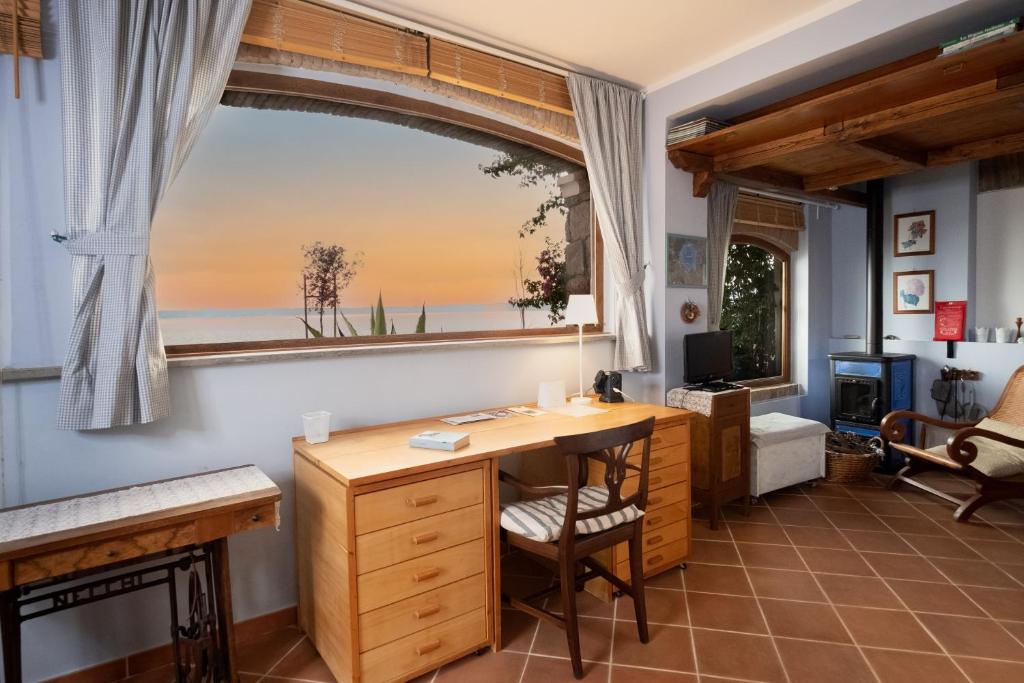 a home office with a desk and a window at La casina incantata in Trevignano Romano