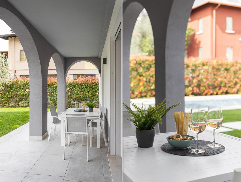 a patio with a table and glasses of wine at Maison Bellini 2 in Toscolano Maderno