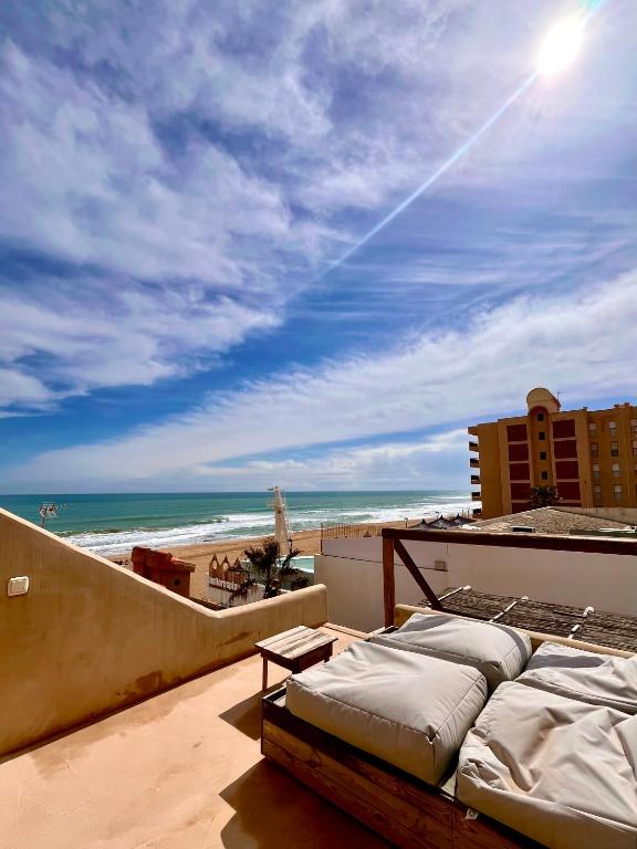 a balcony with a view of the beach and the ocean at Apartamentos Flores playa in La Mata