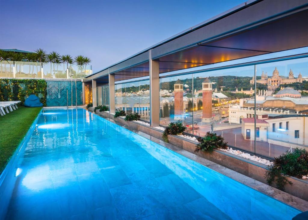 a large swimming pool on the roof of a building at Occidental Barcelona 1929 in Barcelona