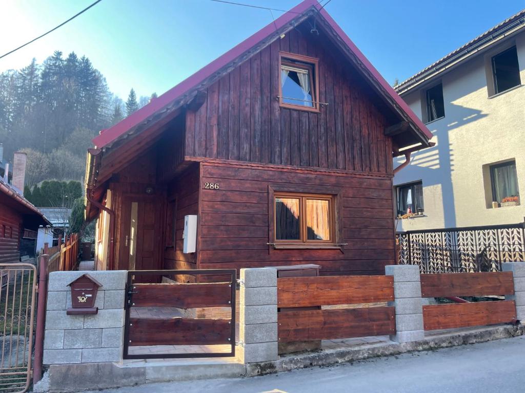 a small wooden house with a fence in front of it at Chalupa Lipka in Kolárovice
