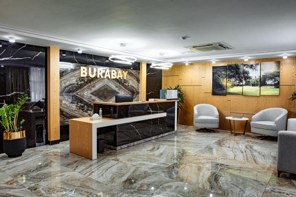 a lobby with a bullaz sign on the wall at Hotel Burabay in Shchūchīnsk