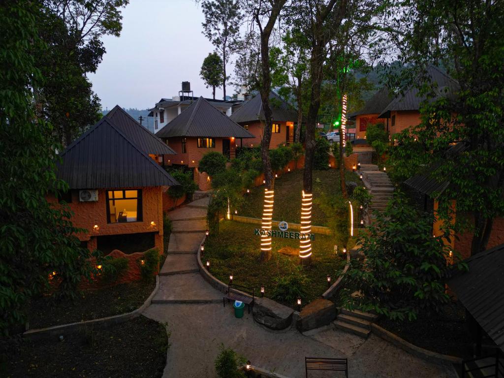 an aerial view of a house with lights in a yard at Kashmeeram Vythiri Wayanad Premium Pool Resort in Vayittiri