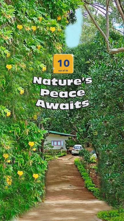 a sign that is hanging over a dirt road at Modern Nature Lodge - Private Holiday Home in Ella