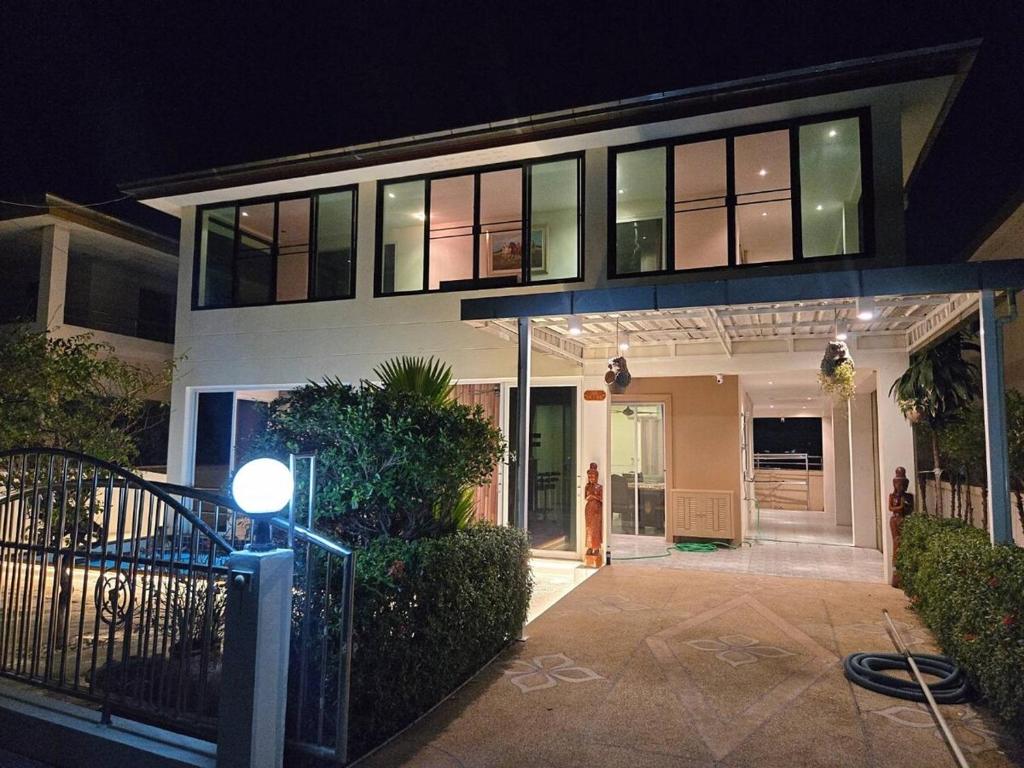 a house at night with a light in front of it at Pool Villa 25 in Ban Nong Pru