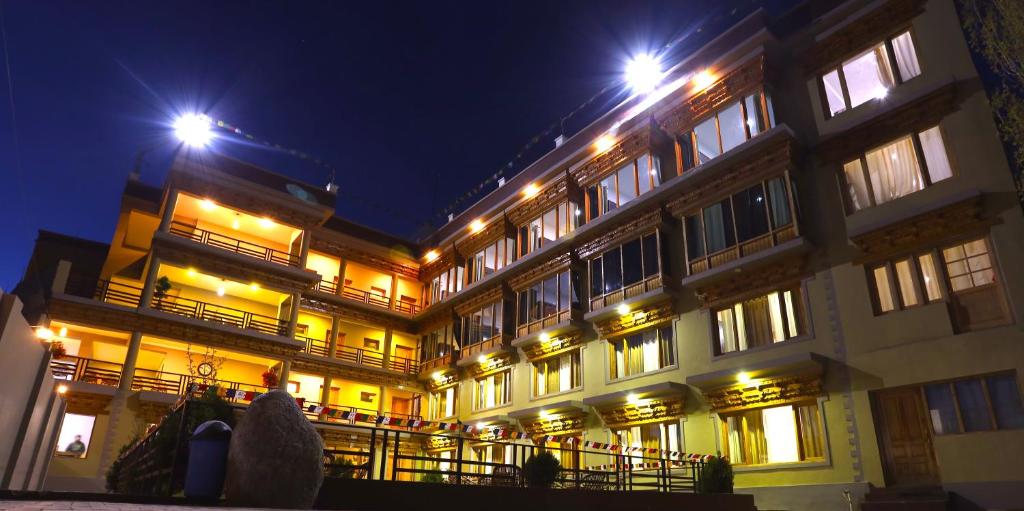 a large building with lights on it at night at Hotel Latso Ladakh in Leh