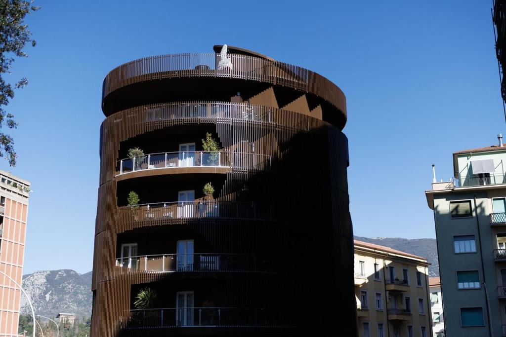 a spiral building with balconies in a city at ZENIT Appartamenti & SPA in Terni