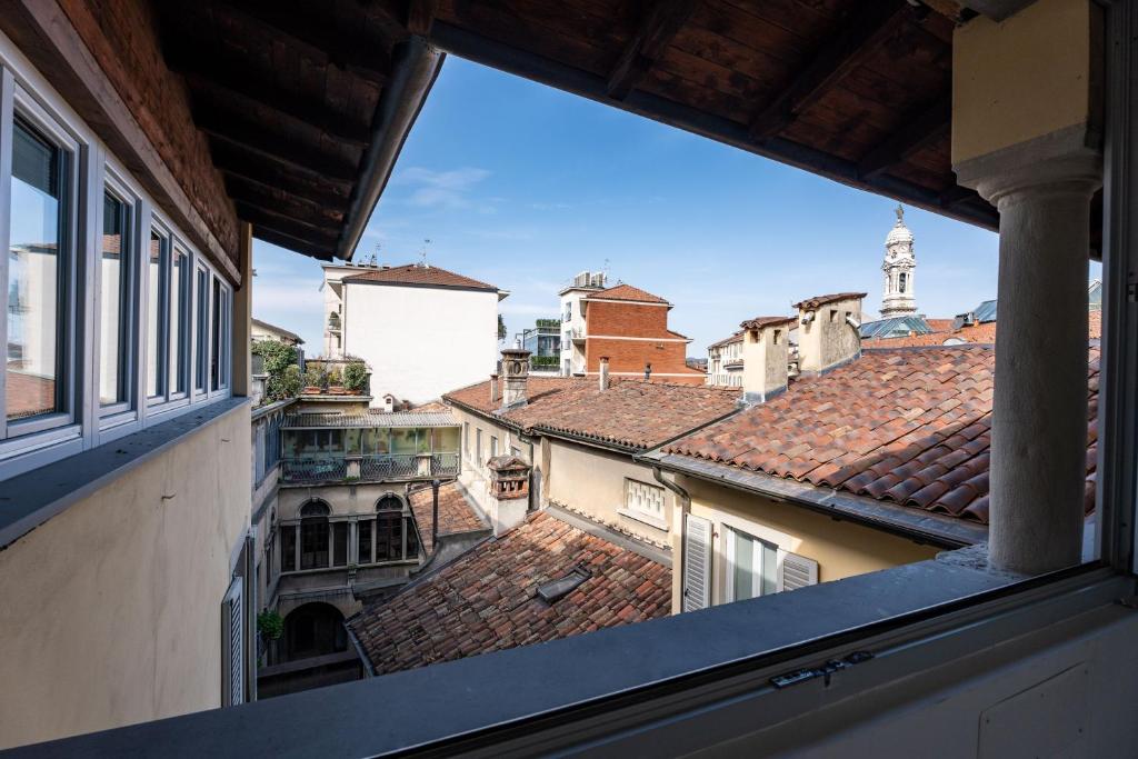 a view from a window of a city with roofs at Stay Bergamo Centro in Bergamo