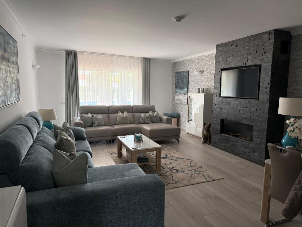 a living room with a couch and a fireplace at Vila Sol, Apartment 468 in Quarteira
