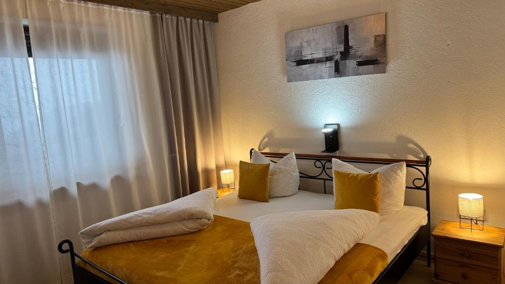 a bedroom with a bed with yellow and white pillows at Apartment Alpen Lodge 52 in Aschau