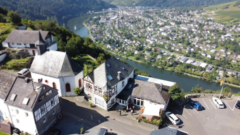 an aerial view of a large house with a river at Moselsteig Lodge in Starkenburg