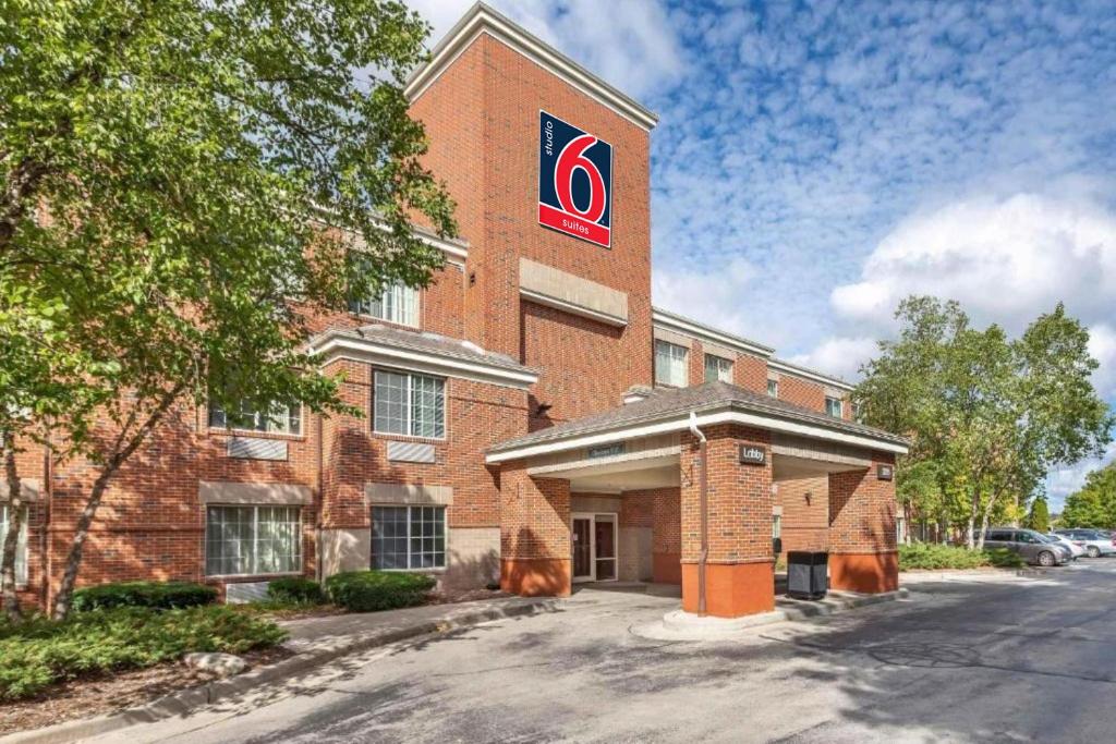 a red brick building with a sign on it at Studio 6 Extended Stay Milwaukee Brookfield WI in Brookfield